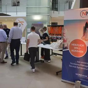 Empfangsbereich beim Nordanex Managed Service Symposium mit Welcome-Banner